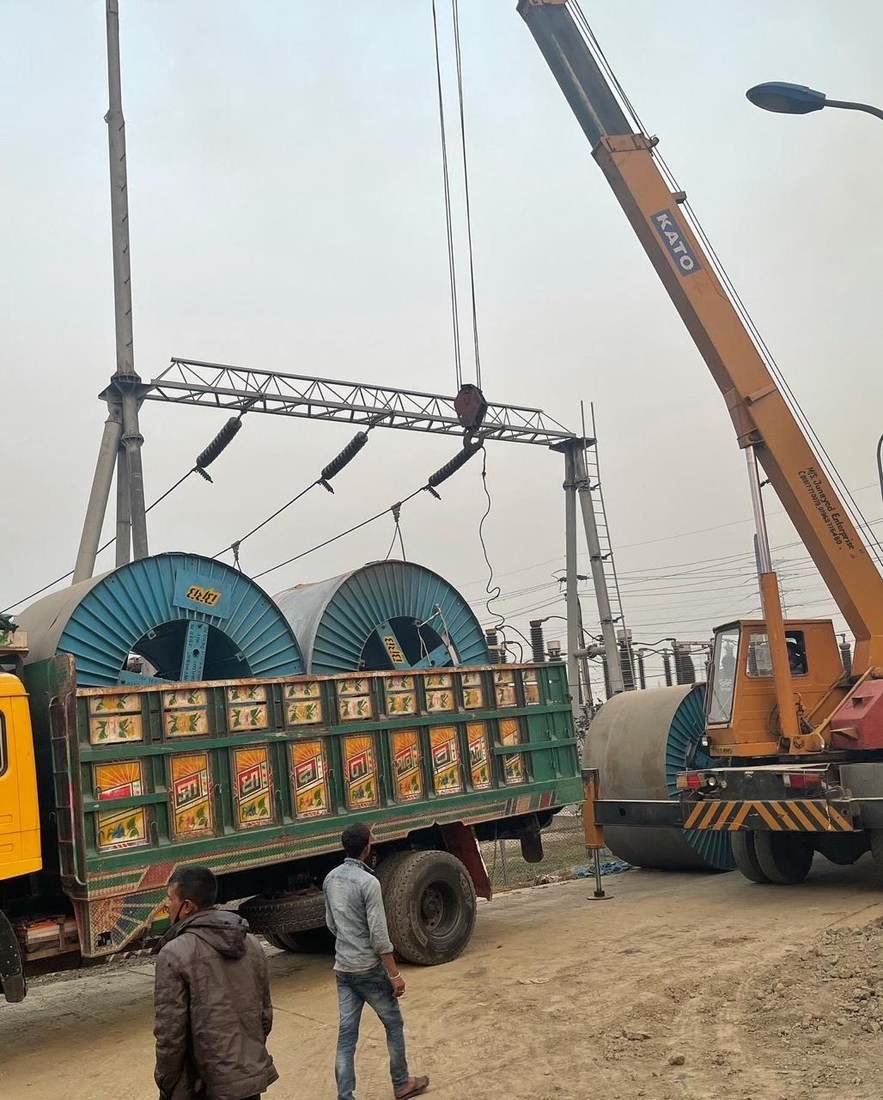 Cable drums being unloaded by crane