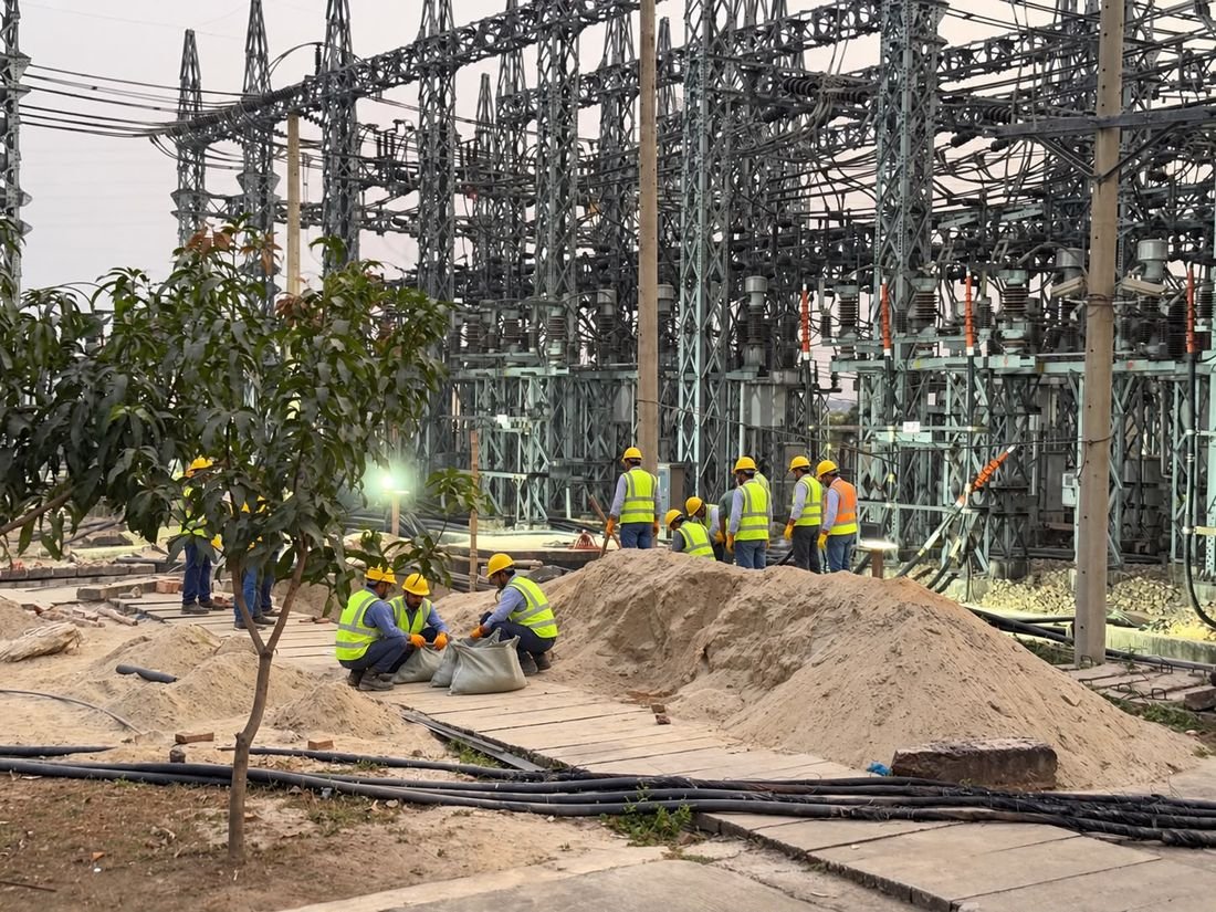 Crew in helmets and safety vests working in a Sub-Station switchyard