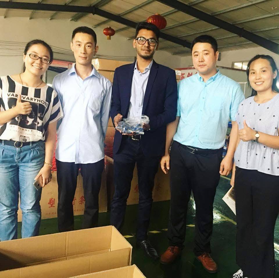 R. M. Corporation representative with a supplier's team, inspecting import materials