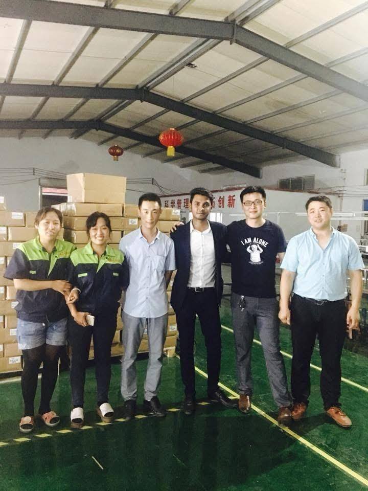 R. M. Corporation representative with a supplier's factory team